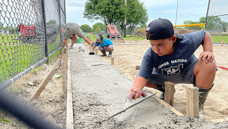 Bartlett Raiders' Kids Installing Concrete Walkway