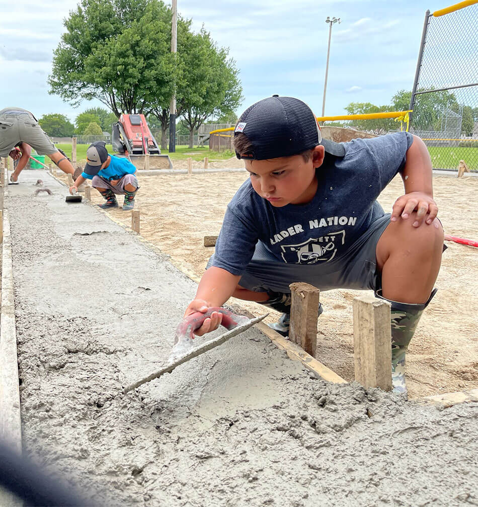 Bartlett Raiders' Kids Installing Concrete Walkway