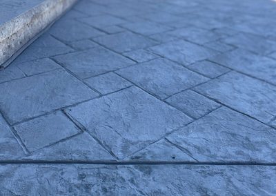 Stone tile stamped concrete patio