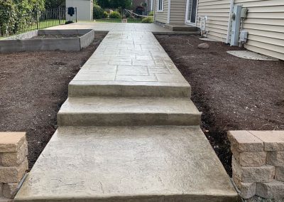 Stamped concrete patio with walkway and stairs